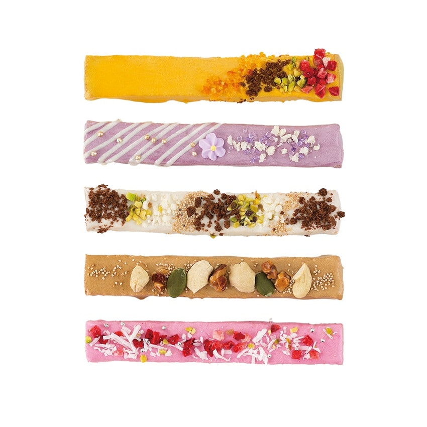 Close-up of five Le Stick Rusk flavors with fruit and nut toppings