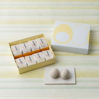 Goma Tamago box with orange dividers and two unwrapped egg cakes