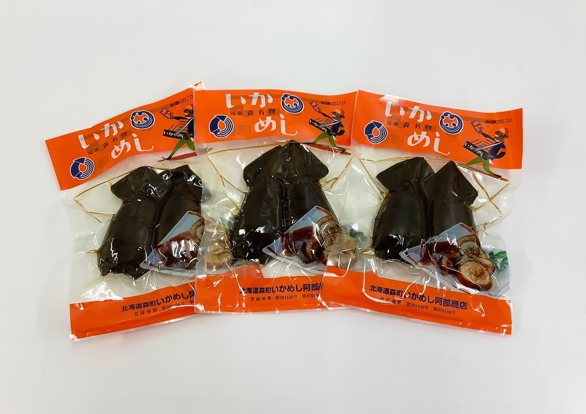 Three vacuum-packed ikameshi pouches laid out, 2 squid per bag