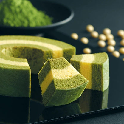 Kyo Baum matcha and soy milk baumkuchen with cross-sections on black background with matcha powder and soybeans